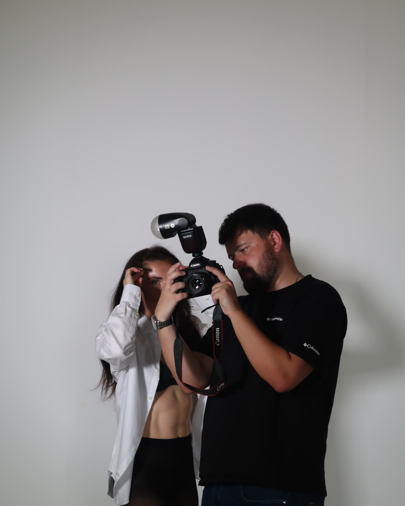 An attendee being shown camera settings against a white wall
