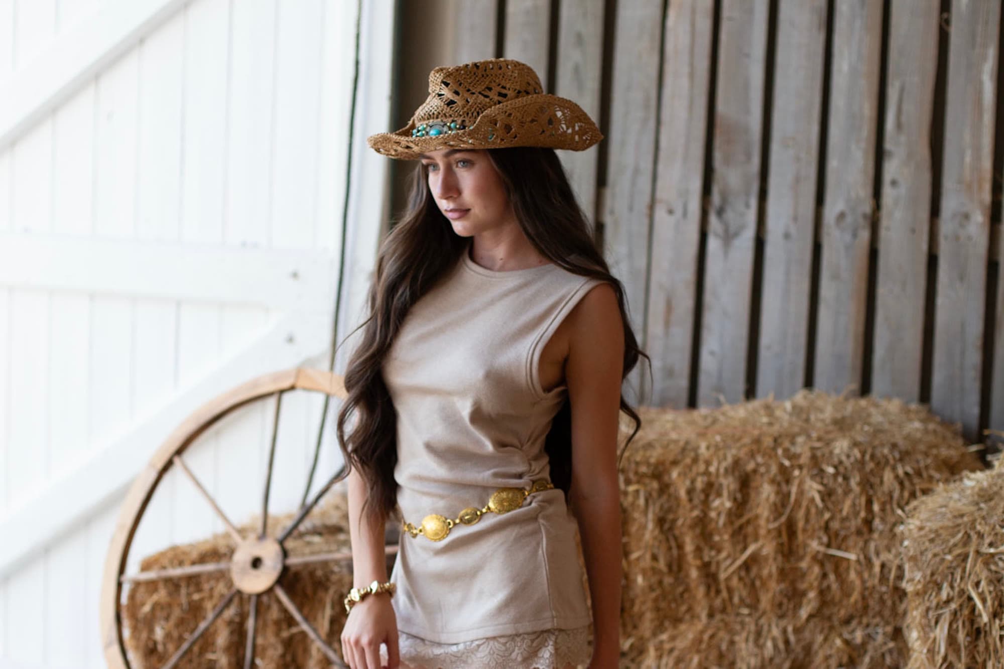 Fashion photograph shot against hay bales and timber cladding