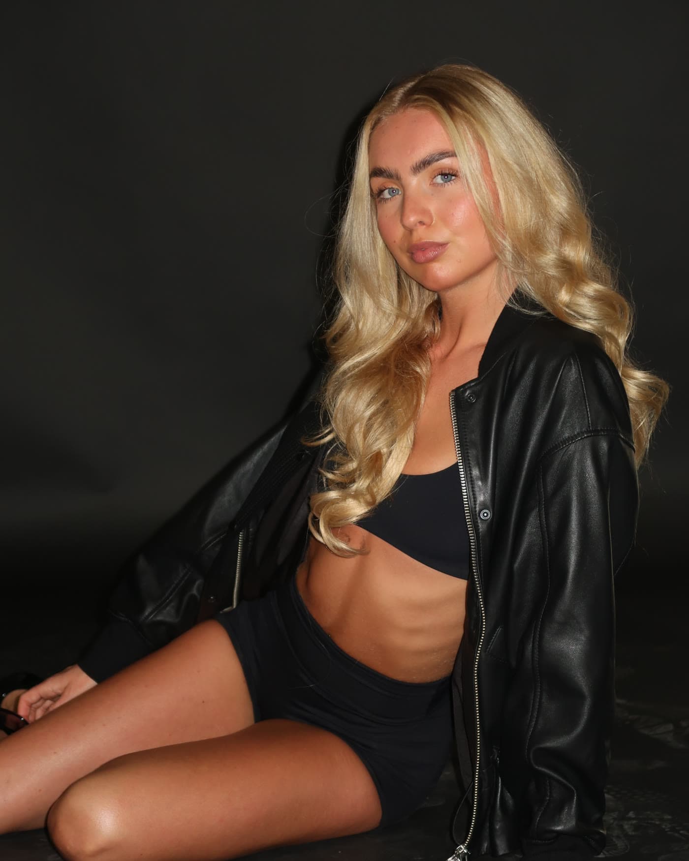 Finished frame, model in a leather jacket against a dark wall