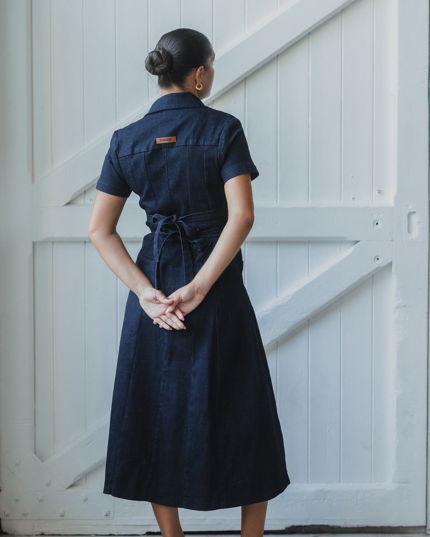 The same denim dress photographed from behind
