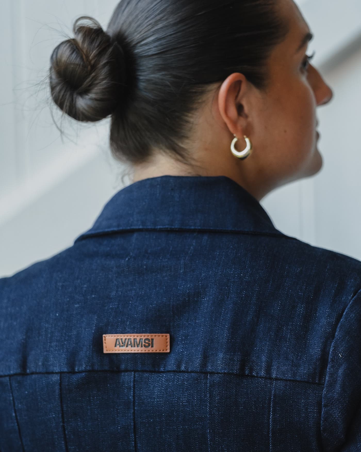 Detail frame, AYAMSI leather patch on a denim collar