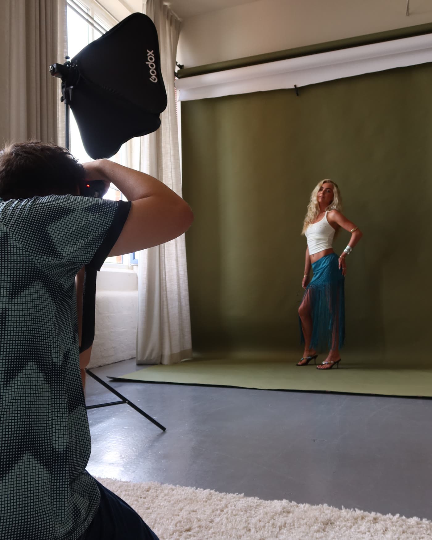A frame being taken on the olive cyclorama, photographer in shot