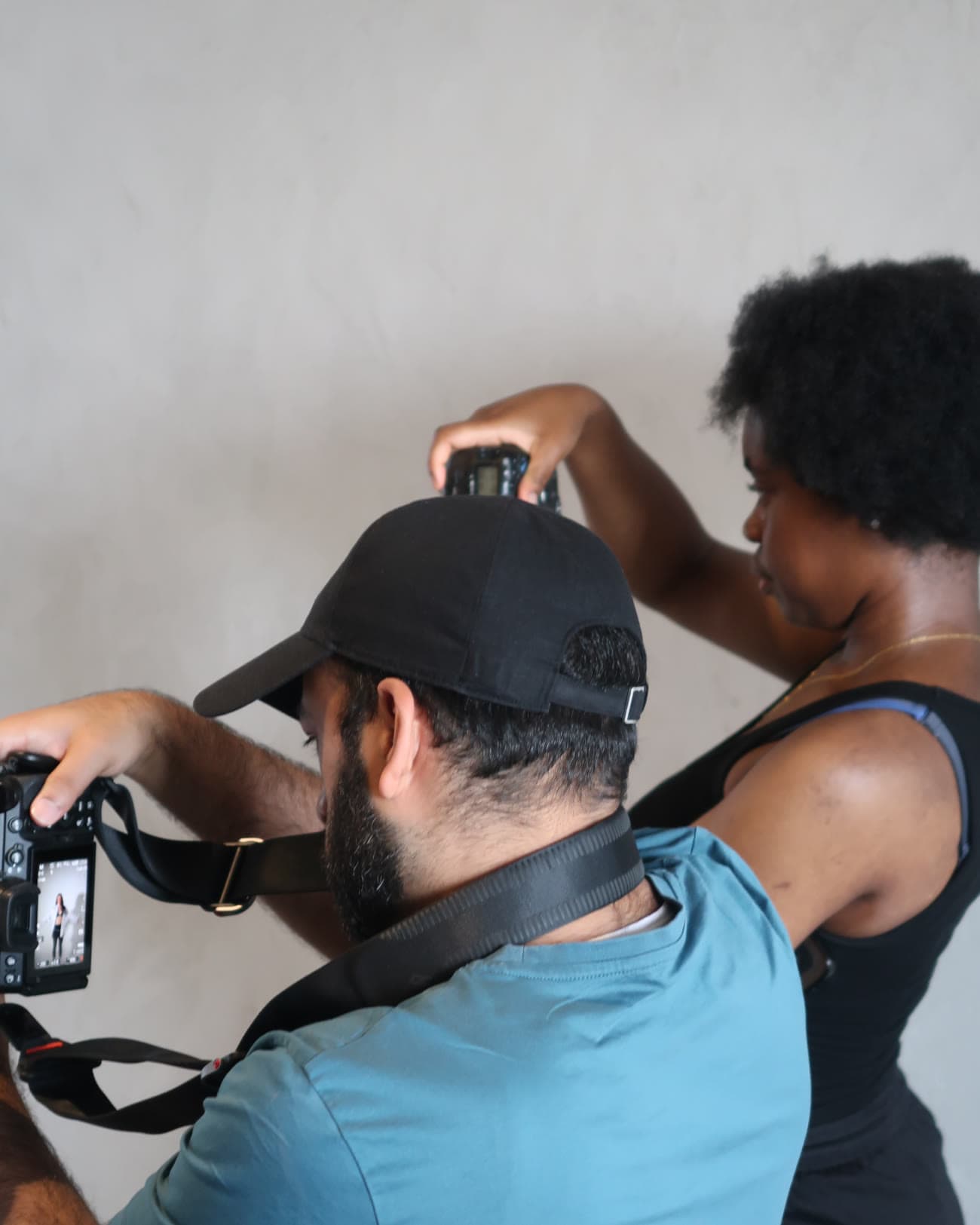 Two attendees setting up a shot together